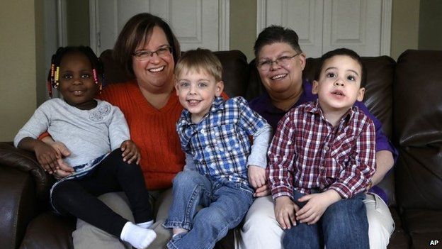 April DeBoer, left, and Jayne Rowse, right, at their home with their adopted children in Hazel Park, Michigan