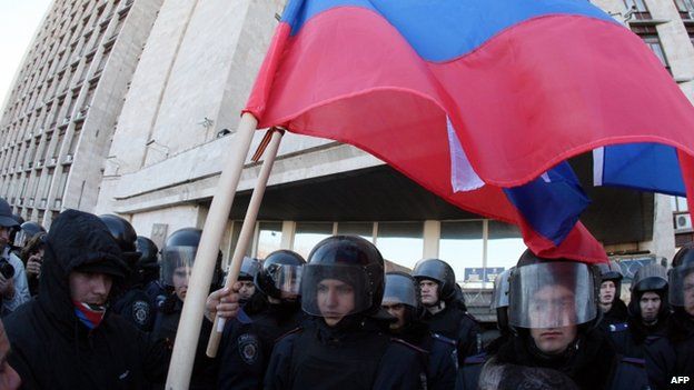 Pro-Russian activists in Donetsk, eastern Ukraine, hold Russian flags in front of riot police. Photo: