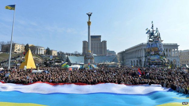 People wave a giant flag - a combination of a Ukrainian and a Crimean flags - during a unity rally in Kiev. Photo: 23 March 2014