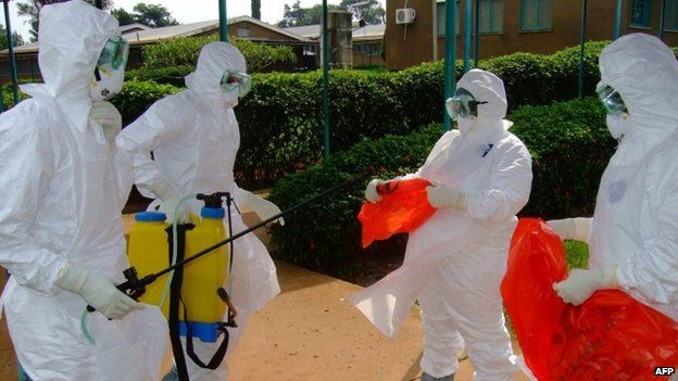 File photo of officials from the World Health Organization in protective clothing preparing to enter Kagadi Hospital in Kibale District, about 200 kilometres from Kampala, where an outbreak of Ebola virus started (28 July 2012)