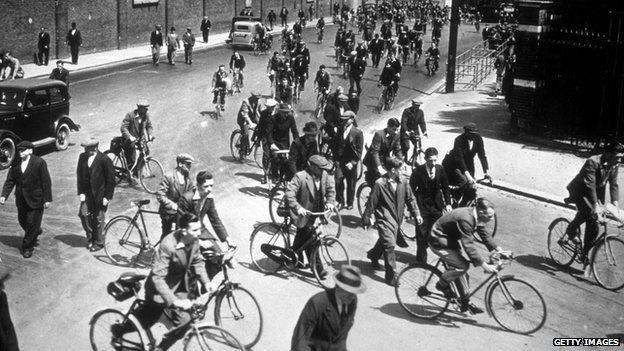 circa 1939: A general view of cyclists arriving for work at Chatham Dockyard