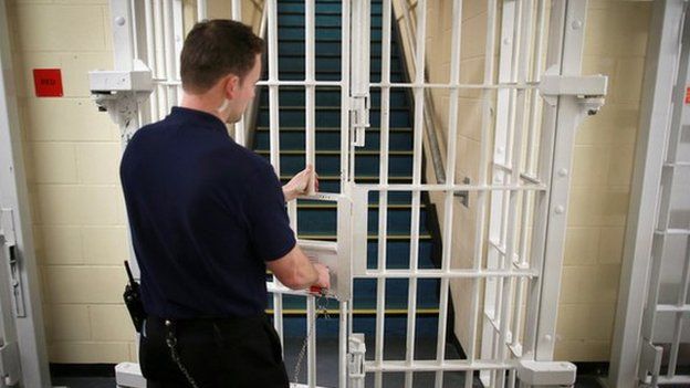 A prison guard locks a door at the Cookham Wood Young Offenders Institution in Rochester