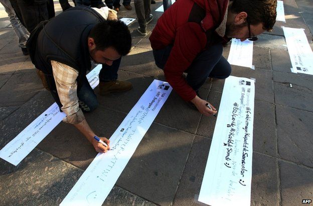 Protests write tweet-style slogans at a protest in Ankara, 21 March