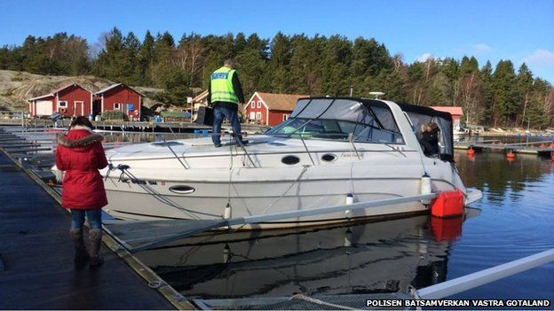 Police inspect an abandoned boat