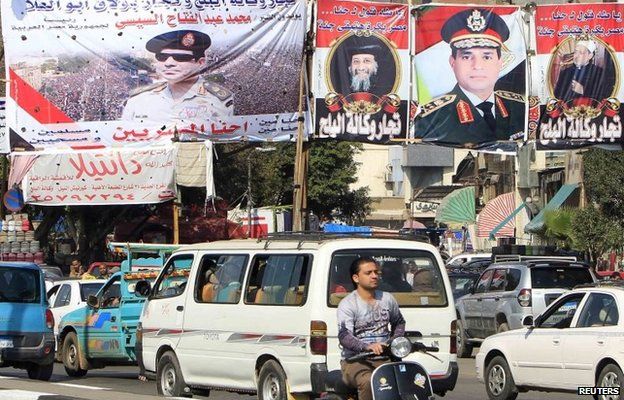 Vehicles pass banners in Cairo praising Field Marshal Abdul Fattah al-Sisi, as well as the Grand Sheikh of al-Azhar, Ahmed al-Tayyib, and Pope Tawadros II of the Coptic Orthodox Church