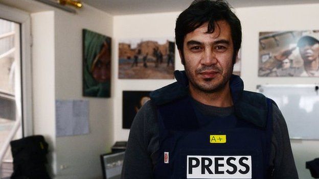 In this picture taken on March 20, 2014, Sardar Ahmad, 40, a Kabul based staff reporter at the Agence France-Presse (AFP) news agency poses for a photo at the AFP office in Kabul