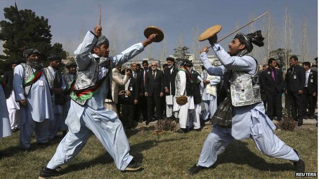 Afghan artists perform a traditional game during the international Nawroz celebrations