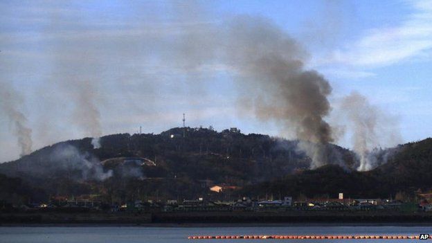 Smoke billows up from Yeonpyeong island near the border against North Korea, in South Korea on 23 Nov 2010