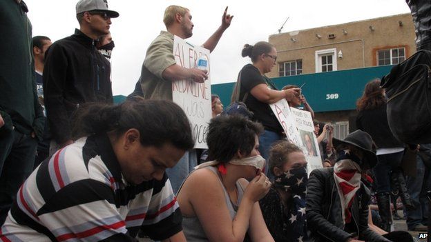 Protesters hold a sit-in in downtown Albuquerque during a rally against recent police shootings on 30 March 2014