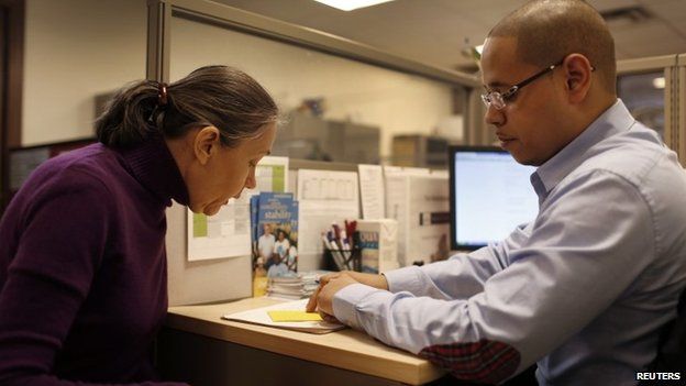 Natalia Pollack is helped to sign up for health insurance through the Affordable Care Act, New York City, 31 March 2014