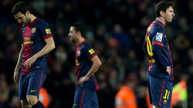 Lionel Messi (R) of Barcelona stands dejected with his teammates after conceding their third goal during the Copa del Rey semi final second leg match.