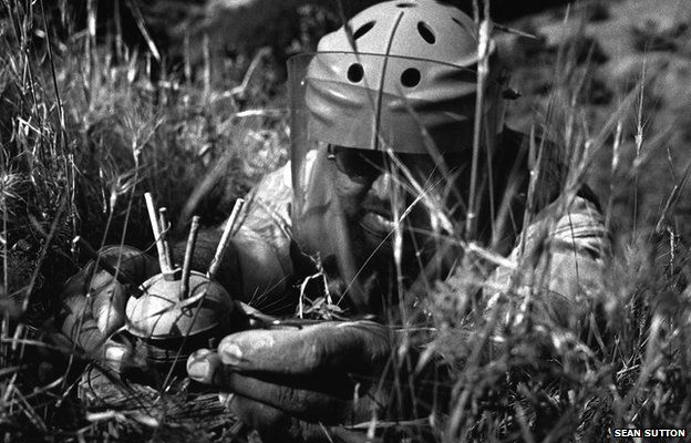 After inserting a special pin to stop the mine initiating, team leader Salahaddin Mahamad carefully lifts the crown out of the body of a V69 Valmara mine, Iraq 2010