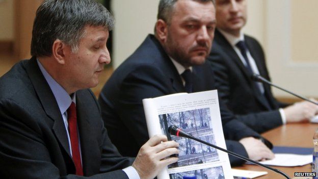 Ukrainian Interior Minister Arsen Avakov shows a photo relating to the shootings. Photo: 3 April 2014