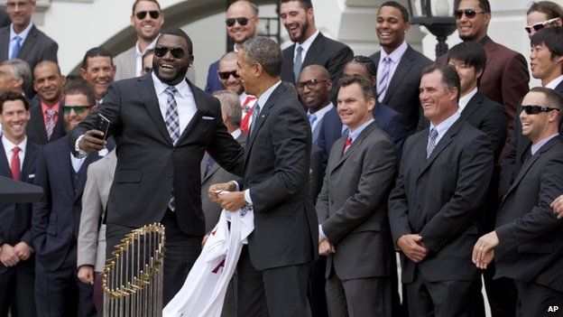 Boston Red Sox player David Ortiz laughs after taking a "selfie" with President Obama
