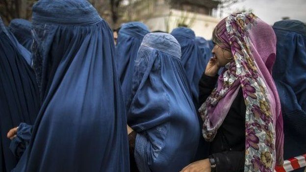 Afghan women wait for their turn to vote at a polling station in Mazar-i-sharif
