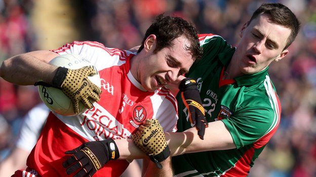 Mayo's Darren Coen challenges Derry's Charlie Kielt at Castlebar