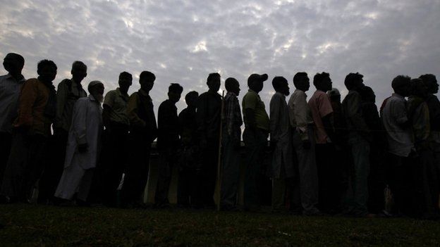 People line up to cast their vote outside a polling station in Nakhrai village in Tinsukia district in the north-eastern Indian state of Assam 7, April 2014.