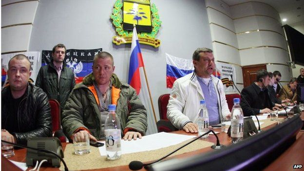 Pro-Russian activists who seized the Donetsk regional government building, take part in a meeting