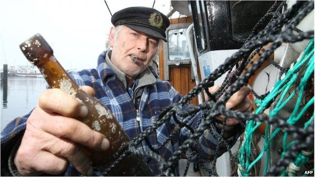 A fisherman holds the world's oldest letter in a bottle