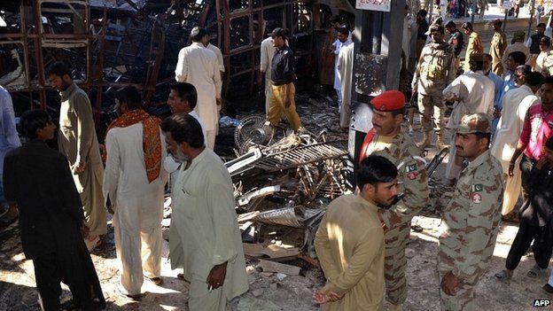 Pakistani security officials and local residents stand in shock after the bomb blast at Sibi station - 8 April 2014