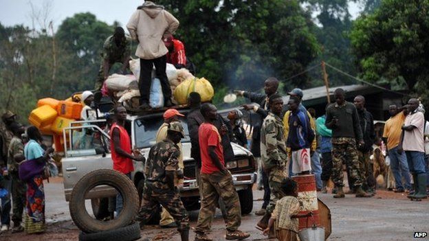 Members of the anti-Balaka Christian militia search a vehicle at a checkpoint in Pissa, CAR on 3 March 2014