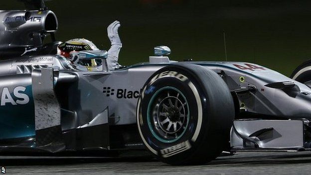 Mercedes driver Lewis Hamilton waves after he wins the Bahrain Formula One Grand Prix