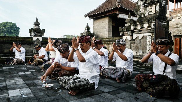 Election officers pray at the temple before opening the polling stations during legislative elections on 9 April, 2014 in Denpasar, Bali, Indonesia