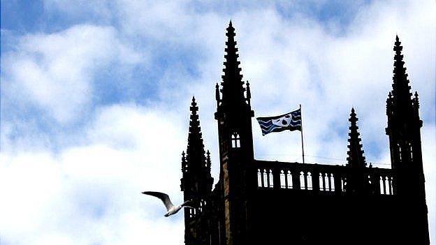 Worcestershire flag flying from cathedral with seagull flying by