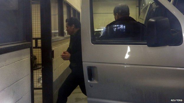 Suspended Senator Patrick Brazeau (left) is escorted into the court house in Gatineau, Quebec, on 10 April 2014