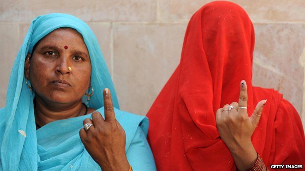 Two women showing their painted finger after voting in Indian general election