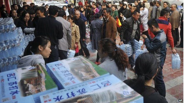 People line up to buy bottled water in Lanzhou on Friday 11 April
