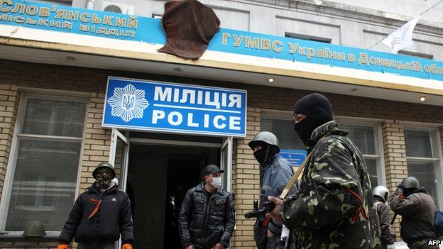 Armed activists guard Sloviansk police station after it was seized by gunmen 12/04/2014