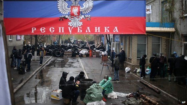 Pro-Russians outside the seized police station in Sloviansk, with a banner reading "Donetsk Republic" - 13 April 2014