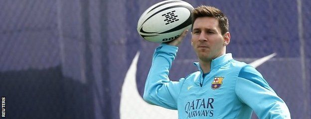 Lionel Messi with a rugby ball