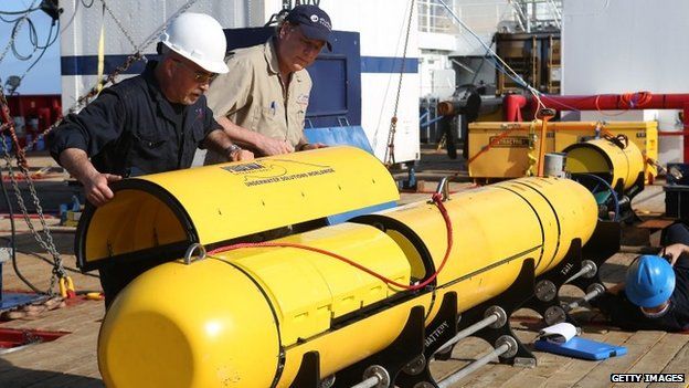 Chris Minor and Curt Newport button up the Autonomous Underwater Vehicle (AUV) Bluefin-21 before it is launched off Australian Defence Vessel Ocean Shield in the search for missing Malaysia Airlines flight MH 370 on 14 April 2014
