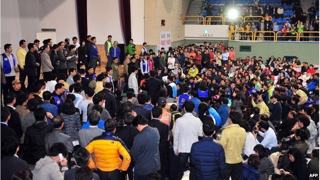 South Korea's President Park Geun-Hye (left, on stage) addresses a hall full of relatives of missing passengers in Jindo