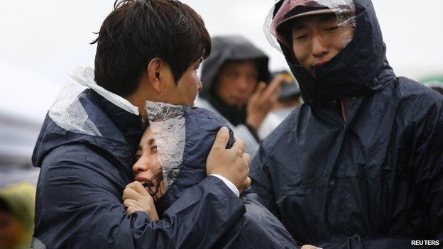 Family members of passengers missing on the overturned South Korean ferry