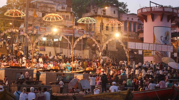 Tourists watch the festival in Varanasi