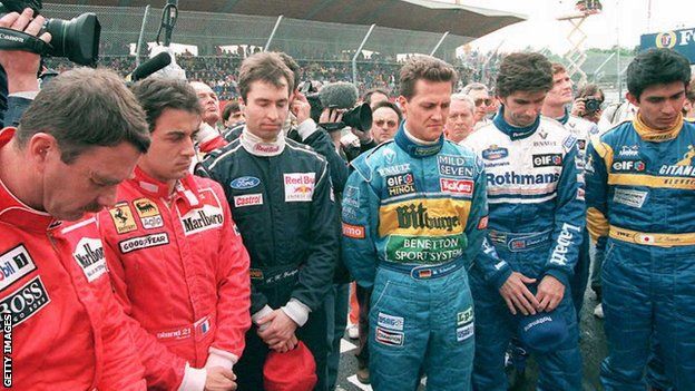 Formula 1 drivers observe a minute of silence to commemorate the first anniversary of the death of fellow drivers Ayrton Senna of Brazil and Roland Ratzenberger of Austria