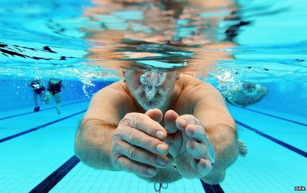Man swims in swimming pool in Karlsruhe, southern Germany