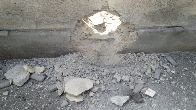 Hole in the wall left by a mortar in Homs