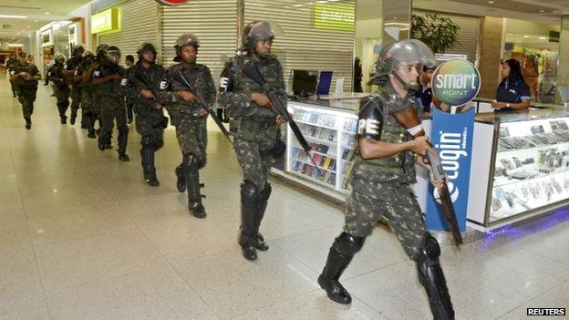 Soldiers patrol a shopping centre during a police strike in Salvador, Bahia state, April 17, 2014.