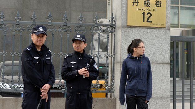 Chinese police stand guard outside a court where two Chinese anti-corruption activists Ding Jiaxi and Li Wei are on trial in Beijing's Haidian district on 8 April, 2014