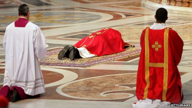 Pope Francis prays on the floor during a Papal Mass with the Celebration of the Lord"s Passion inside St Peter"s Basilica on April 18