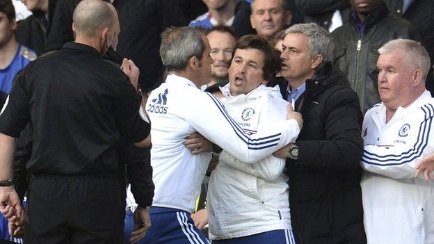 Jose Mourinho restrains Rui Faria as Mike Dean looks on