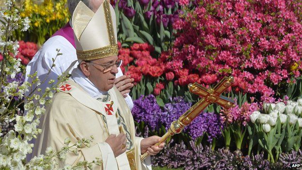 Pope Francis walks past the flowers in St Peter's Square on 20 April 2014