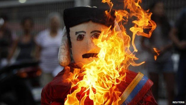 Protesters burn effigies of President Nicolas Maduro, 20 April