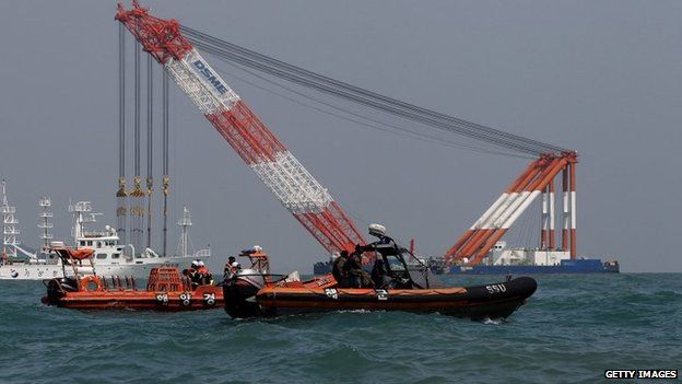 The South Korean coast guard searches for missing passengers at the site of the sunken ferry off the coast of Jindo Island on 20 April 2014 in Jindo-gun, South Korea