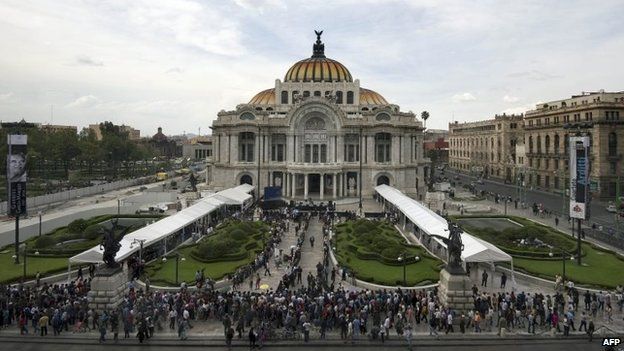 People wait outside the Fine Arts Palace in Mexico City on April 21, 2014