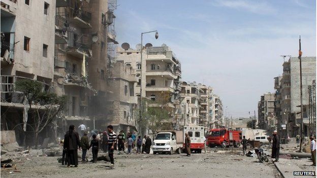 Men inspect a site hit by what activists said was a barrel bomb dropped by pro-Assad forces in the Dahra Awad neighbourhood of Aleppo April 20